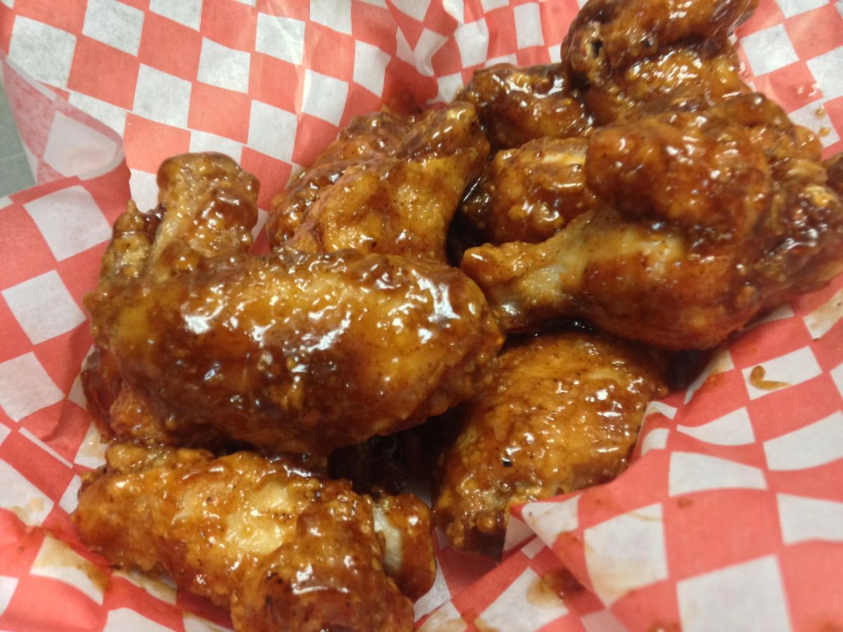 Honey-glazed wings in a red-checker basket at Dillo's